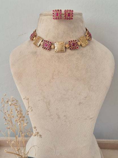 Antique gold choker necklace set with textured square panels, pink stone flower motifs, and matching stud earrings