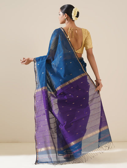 Bright cobalt blue and purple saree draped neatly to highlight delicate handwoven pattern and fabric texture