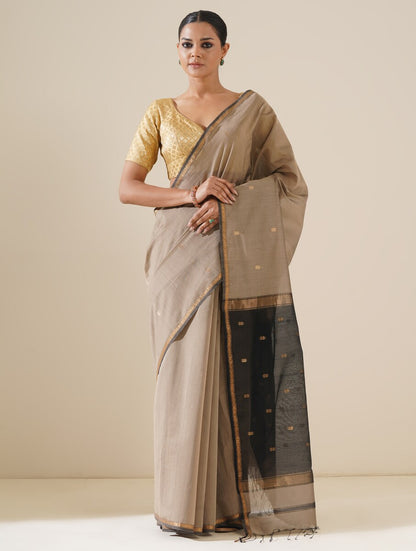 Beautiful grey and black saree draped on mannequin highlighting traditional craftsmanship and silk texture