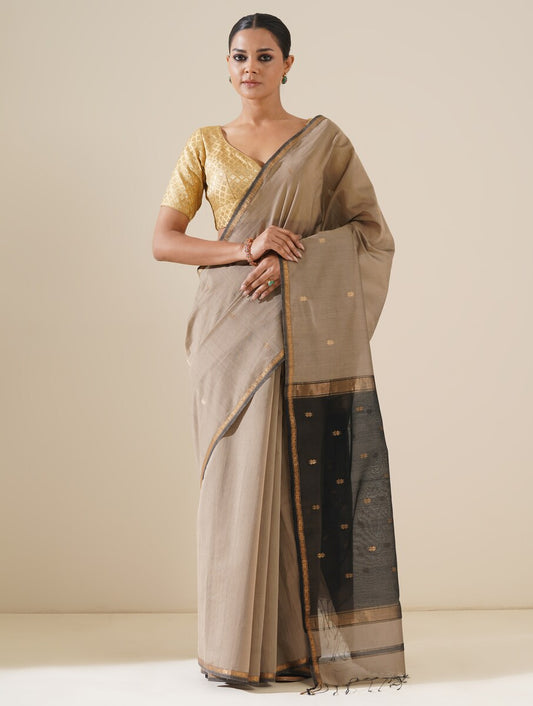 Beautiful grey and black saree draped on mannequin highlighting traditional craftsmanship and silk texture