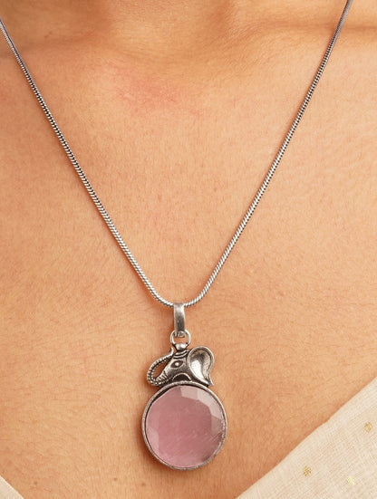 Pink and silver necklace, earrings, ring set on soft background