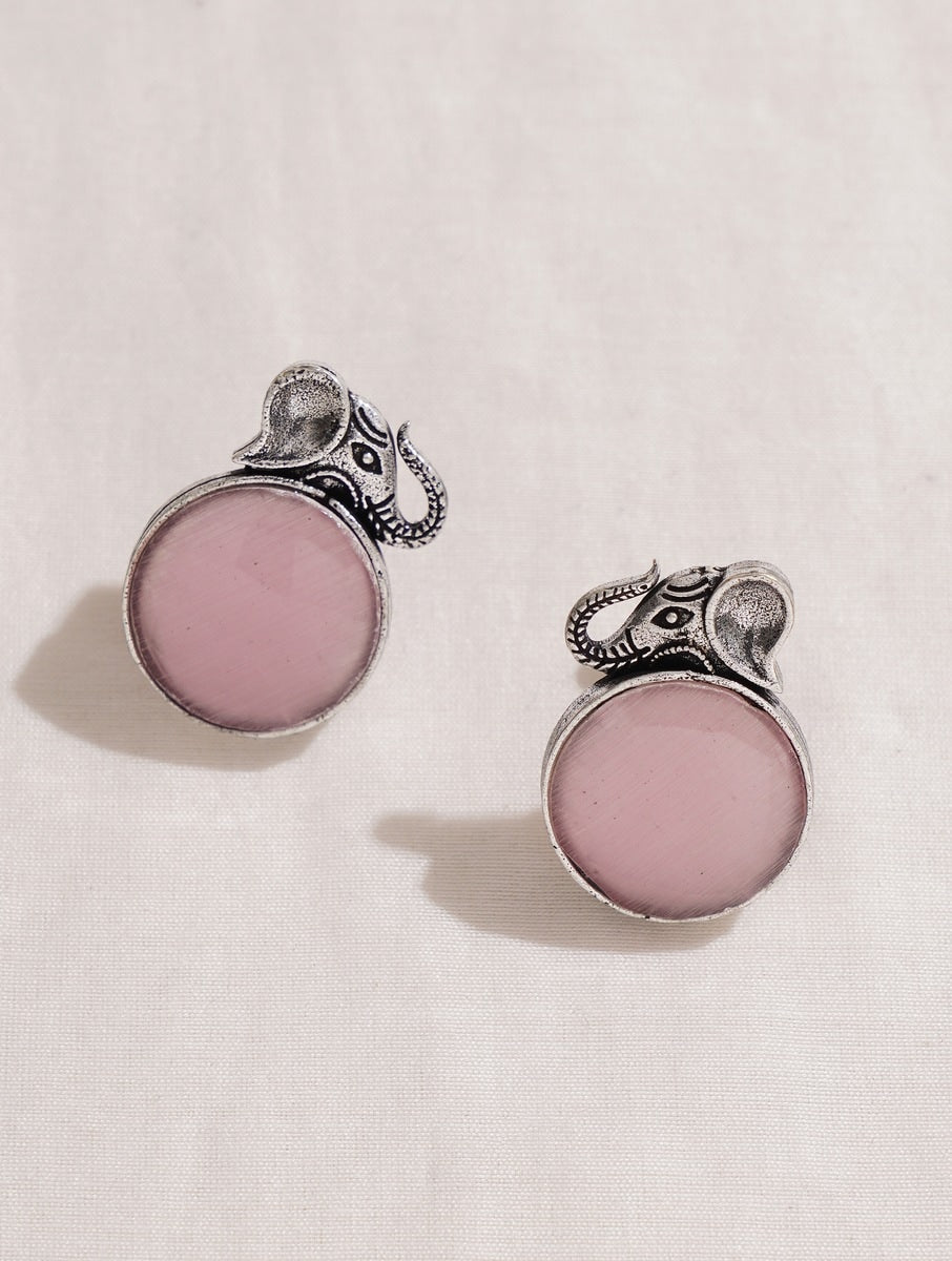 Pink and silver necklace, earrings, ring set on soft background