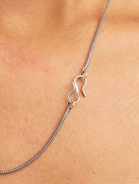 Pink and silver necklace, earrings, ring set on soft background