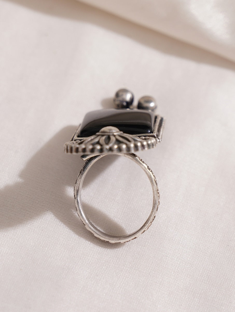 Silver band oxidized ring, close-up accent on handmade texture