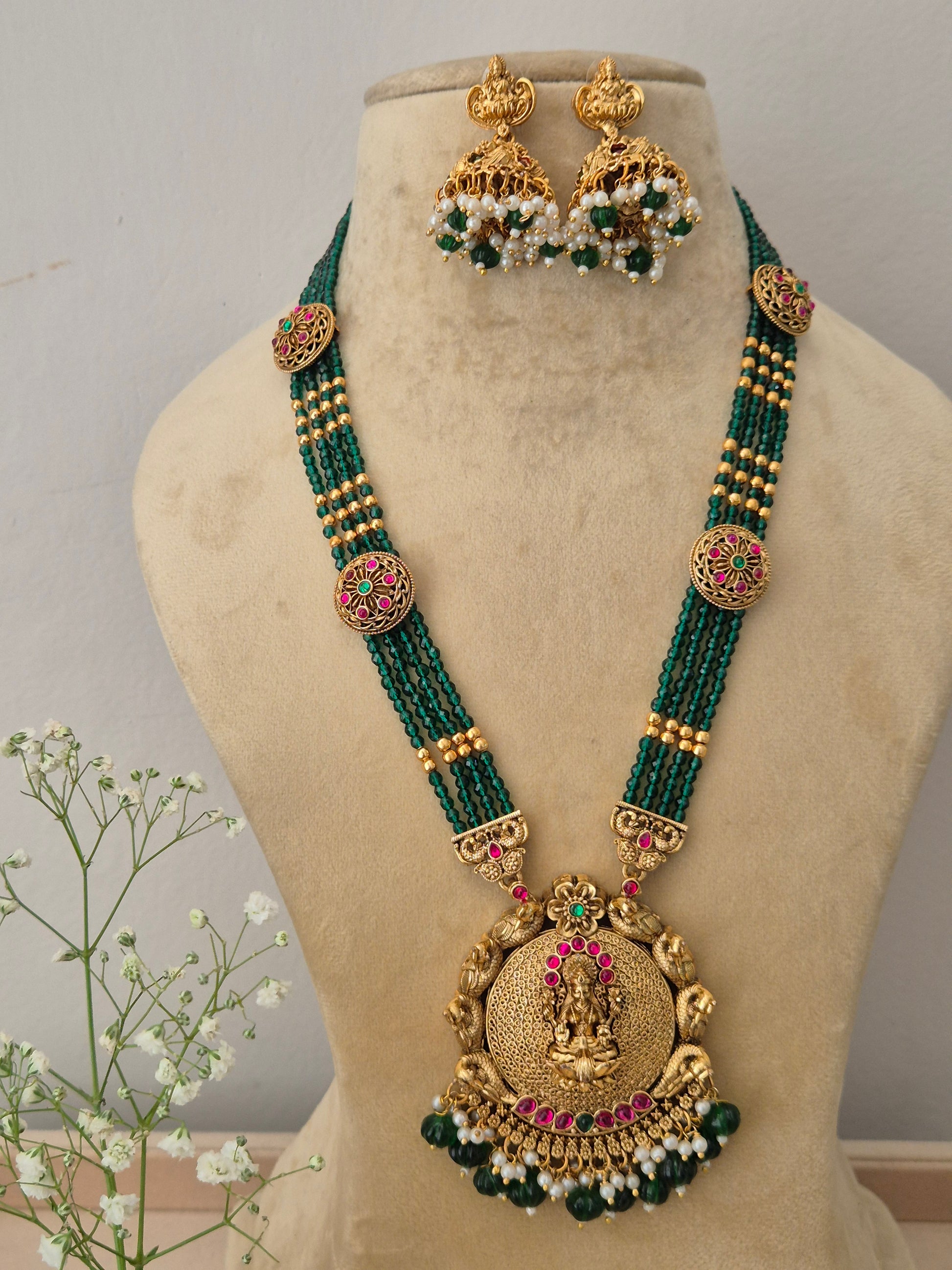 Elegant traditional gold-toned festive jewelry set with intricate green beaded layers, Naitri gold-plated Aalia temple necklace and earring set with green beads by  naitri.in