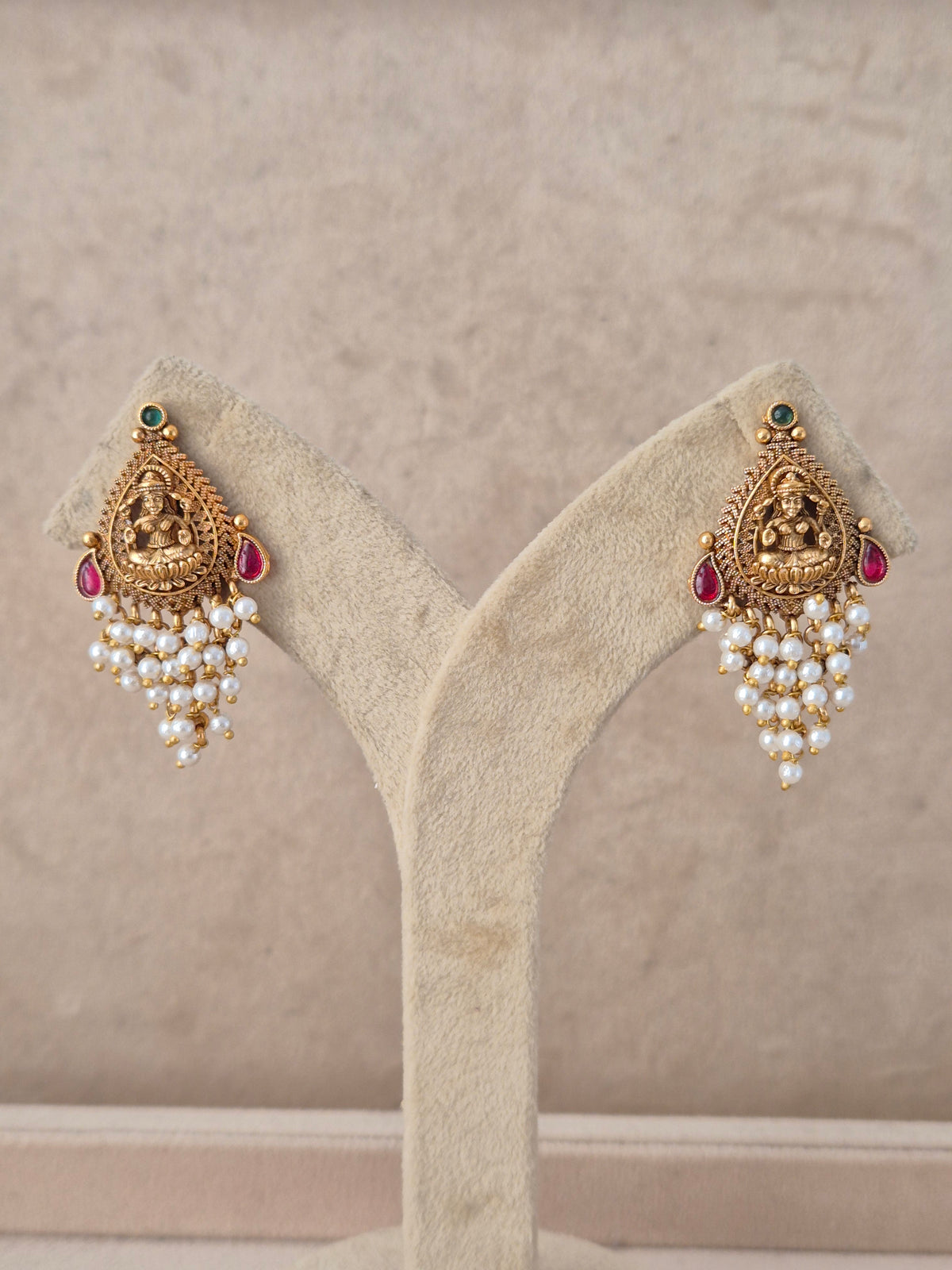 Artisan brass alloy earrings showcasing classic ethnic craftsmanship, textured gold finish, and delicate pearl detailing by Naitri.in