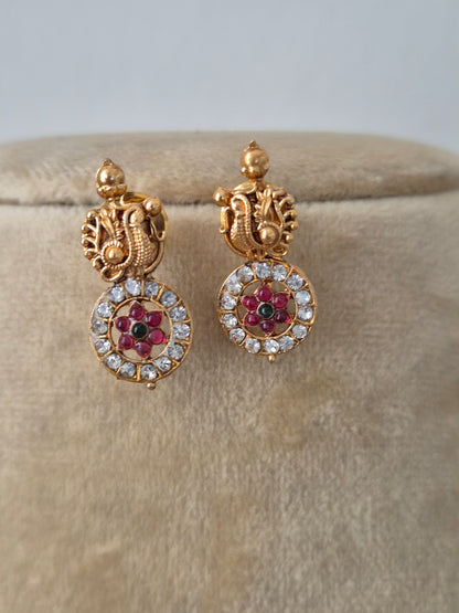Gold-plated Indian ethnic earring with delicate hanging coin-shaped charms accented by a halo of small white crystals, by naitri.in