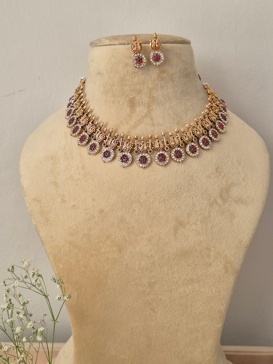 Antique gold choker necklace with dangling circular coin charms and matching earrings, by naitri.in