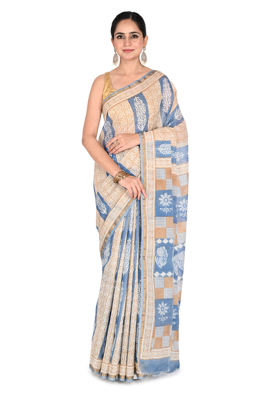 Woman modeling a blue and beige hand block printed cotton silk saree with intricate geometric patterns and a classic drape by naitri.in