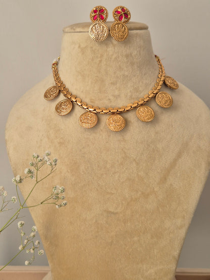 Brass alloy necklace set in antique gold finish, embellished with pink synthetic stones and intricate floral metalwork, Modern Indian ethnic jewelry set featuring a delicate pink stone floral necklace and matching studs for festive occasions by naitri.in