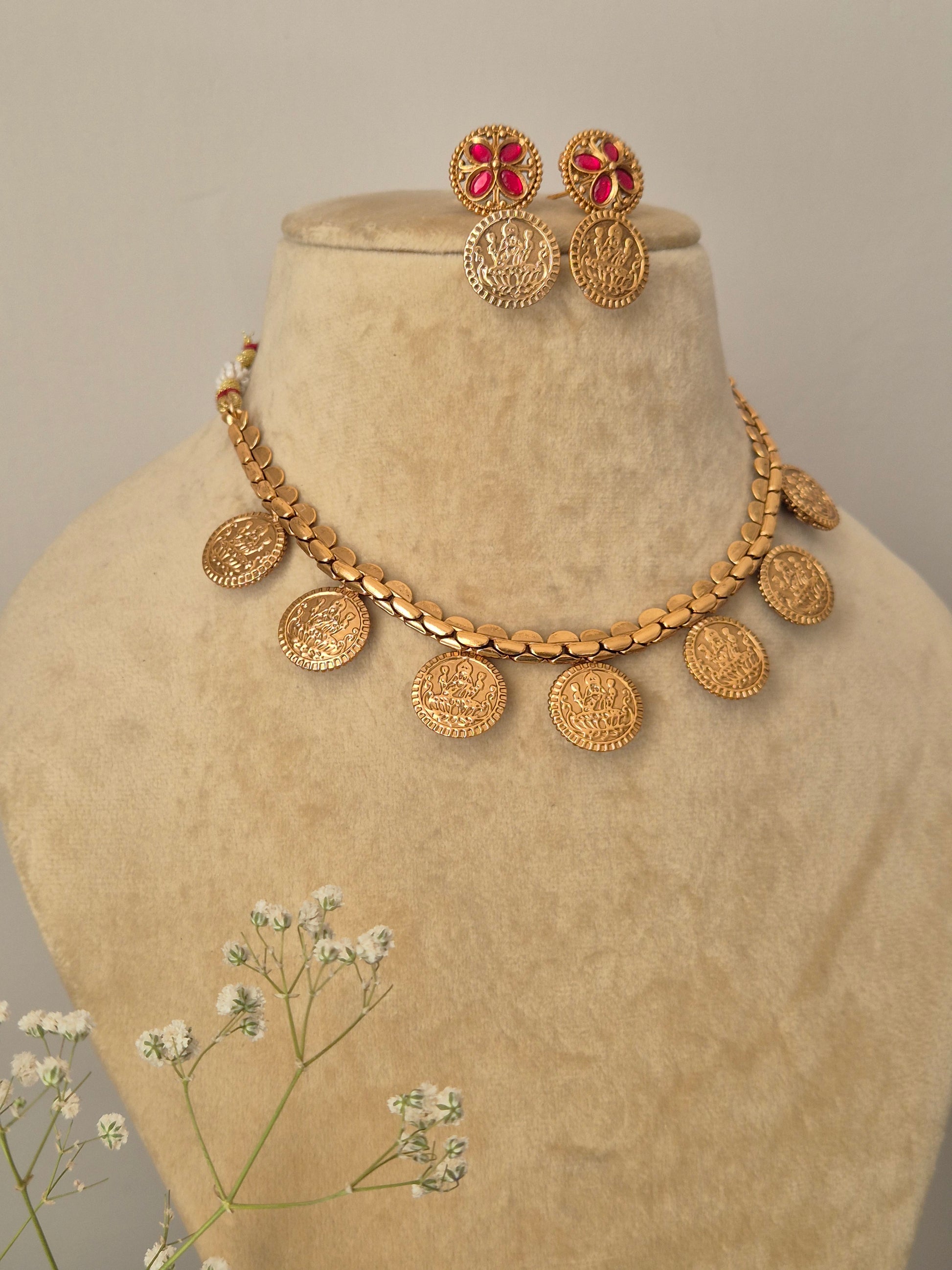 Elegant golden choker necklace with circular links and goddess crafted with coordinating earrings by naitri.in