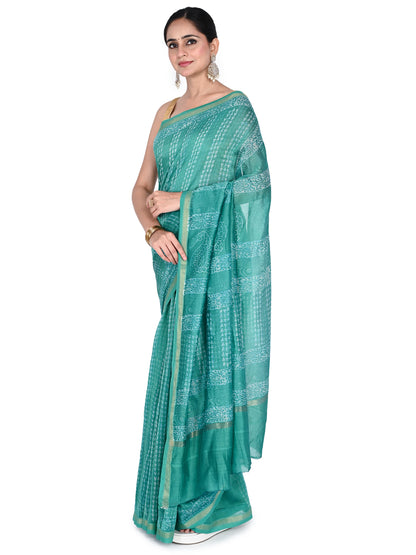 Full-length view of the Advita saree in seafoam green, featuring intricate white hand-block patterns and a shimmering silk-blend texture, paired with a sleeveless gold blouse by  naitri.in