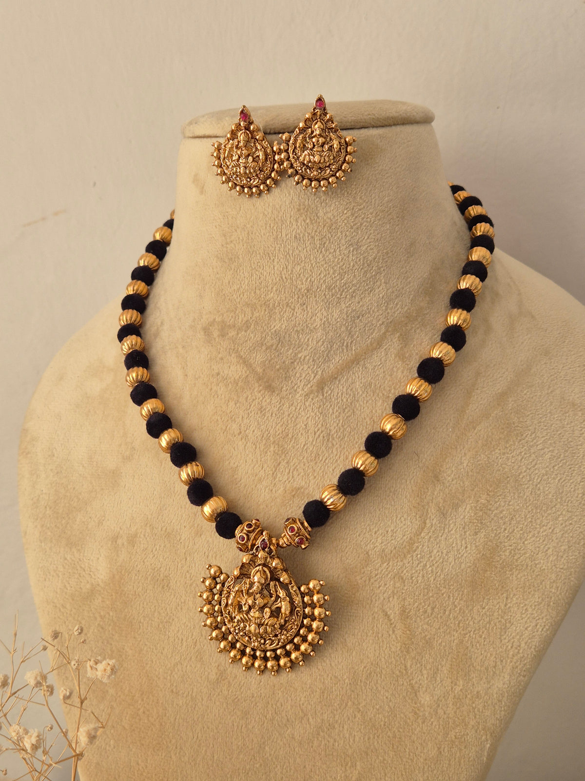 Handcrafted brass alloy traditional Indian pendant necklace on a black beaded chain with stone embellishments by Naitri.in