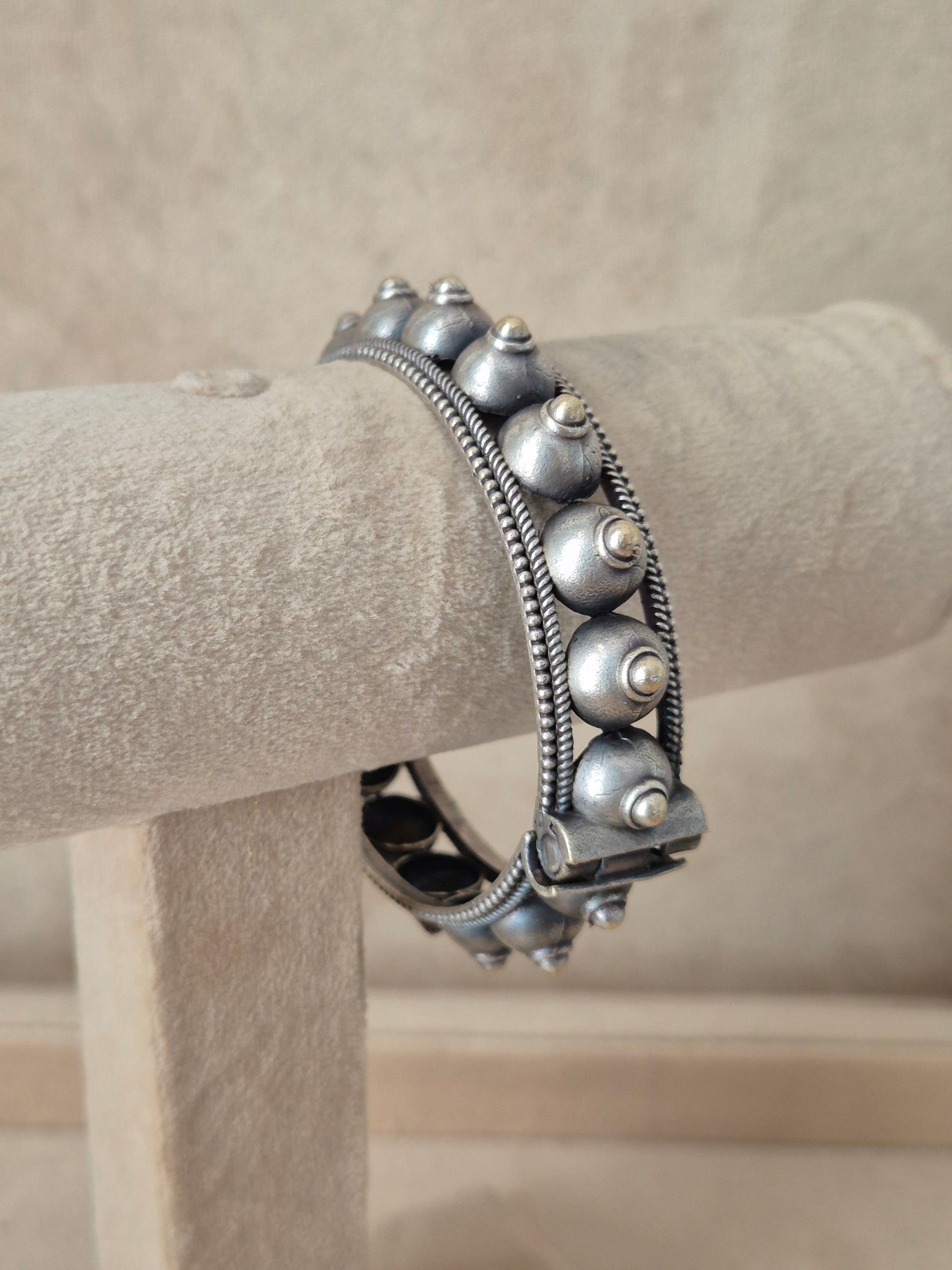 Intricately detailed silver oxidized geometric bangle bracelet by naitri.in