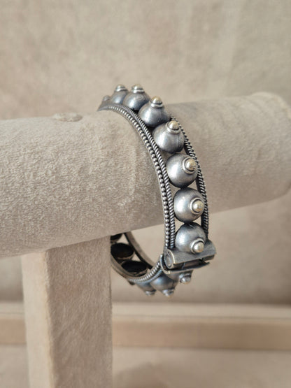 Intricately detailed silver oxidized geometric bangle bracelet by naitri.in