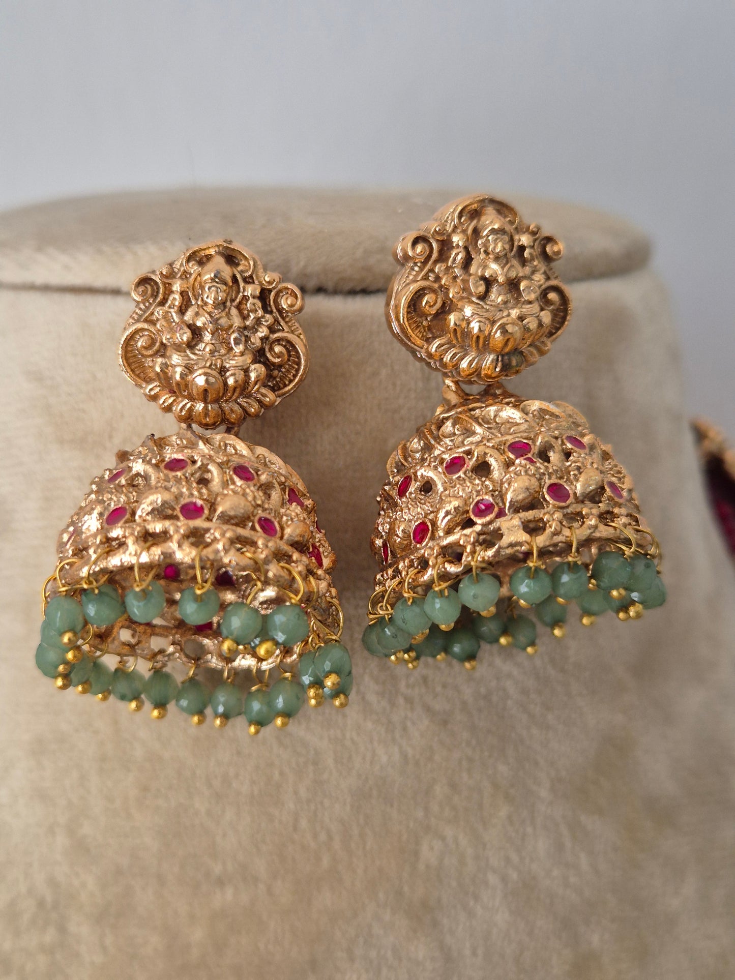 Modern Indian ethnic imitation earring a detailed gold temple pendant with hanging green beads by naitri.in 