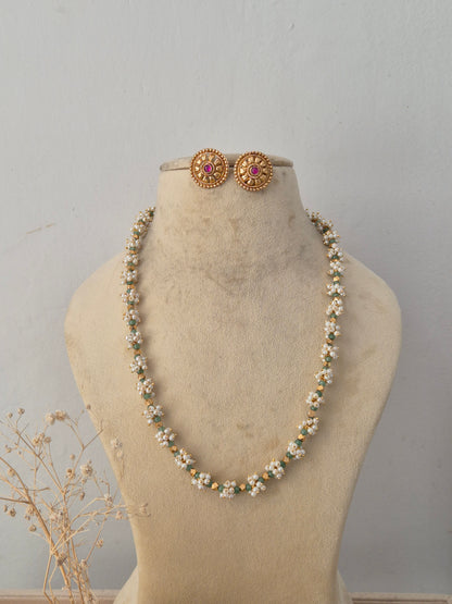 Handcrafted brass alloy traditional Indian pendant necklace on a black beaded chain with stone embellishments by Naitri.in