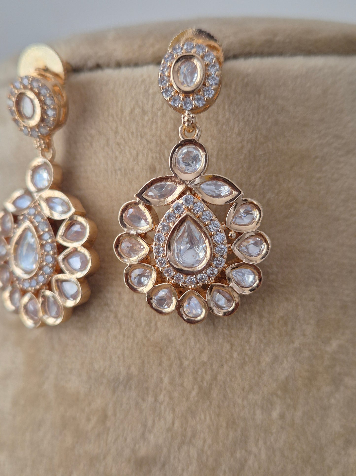 Elegant handcrafted American Diamond earring in rose gold finish with floral motif pendant and matching earrings for festive wear y naitri.in 