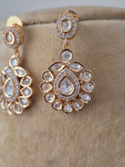 Elegant handcrafted American Diamond earring in rose gold finish with floral motif pendant and matching earrings for festive wear y naitri.in 