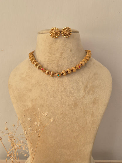 Alisha Necklace Set by Naitri featuring gold-toned textured beads and matching round earrings by Naitri.in