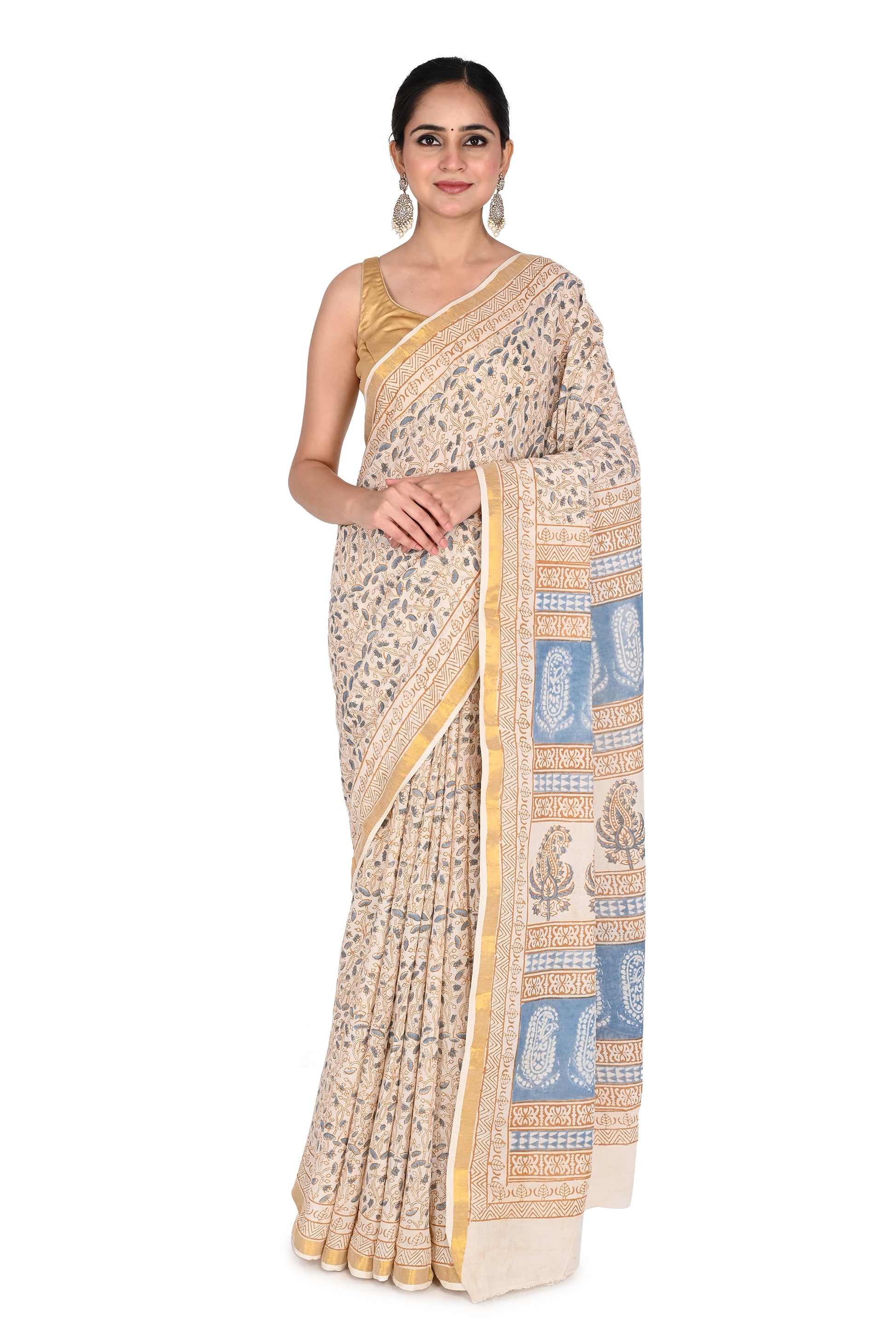 Woman wearing the Ambika hand block printed cotton saree in beige and white with delicate blue floral patterns by naitri.in