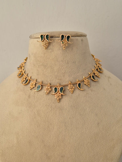 Amita Necklace Set featuring a traditional gold mangalsutra-style black beaded chain with an intricate temple pendant and matching earrings by Naitri.in