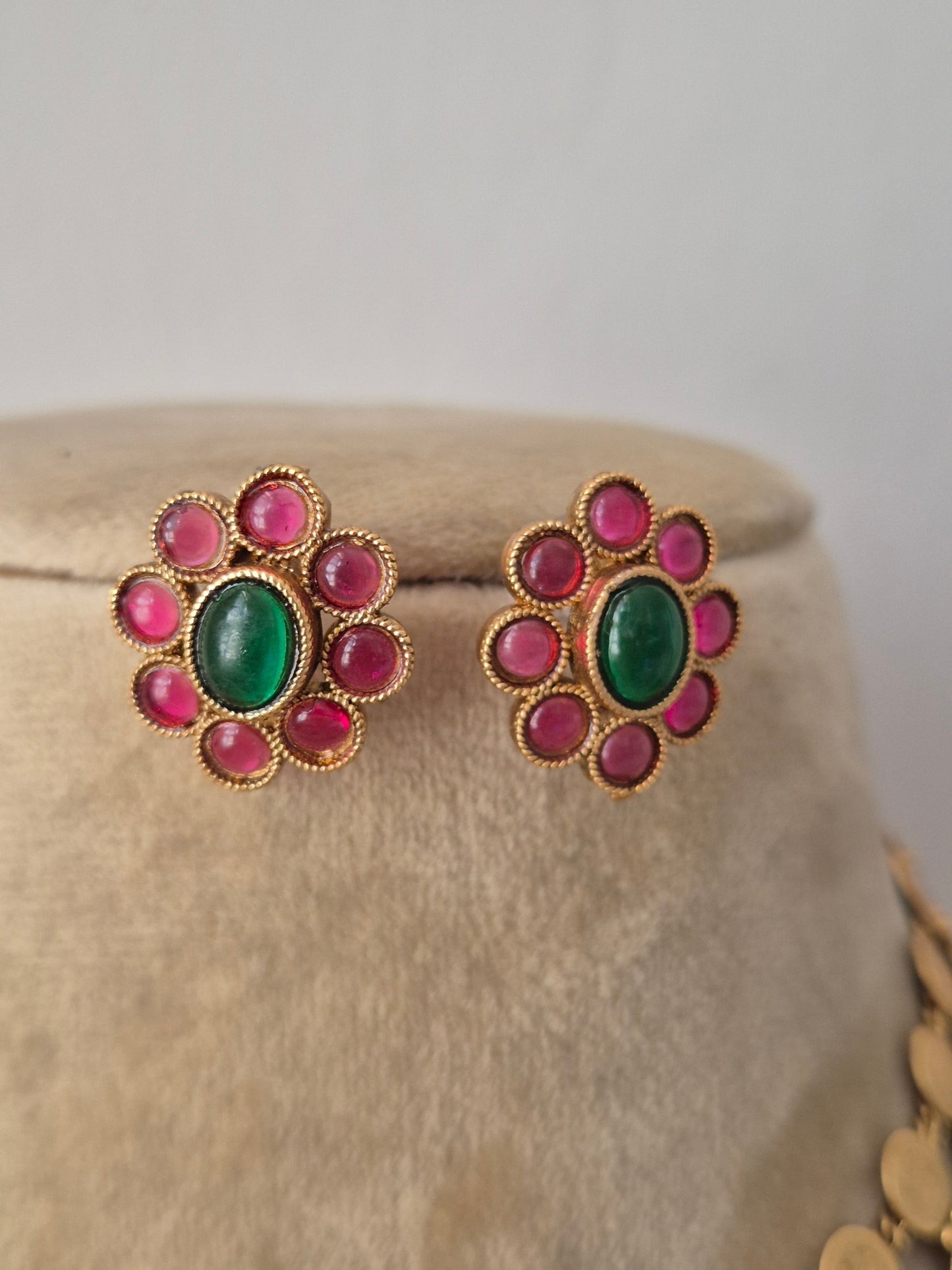 Gold-plated ethnic earring and a central emerald-green and ruby-pink  gemstone flower stud earrings by naitri.in
