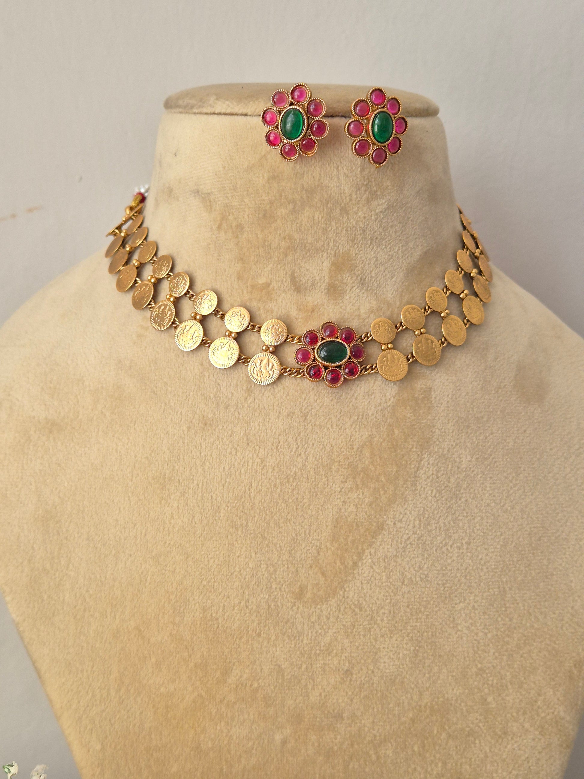 Handcrafted antique gold statement jewelry set showcasing festive pink and green floral accents by naitri.in
