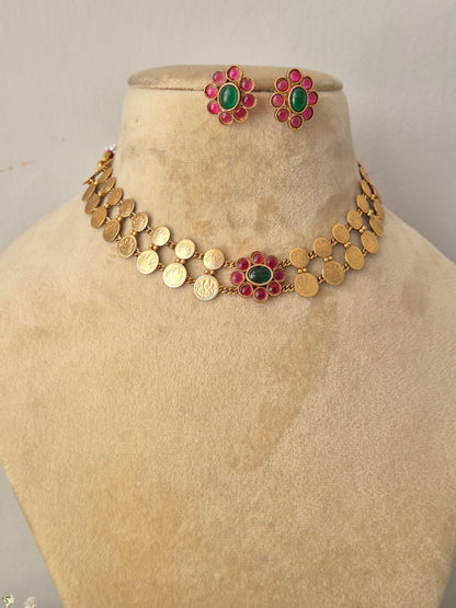 Handcrafted antique gold statement jewelry set showcasing festive pink and green floral accents by naitri.in