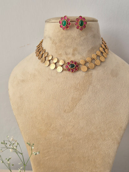 Antique gold choker necklace featuring a central pink and green floral pendant, with matching earrings by naitri.in
