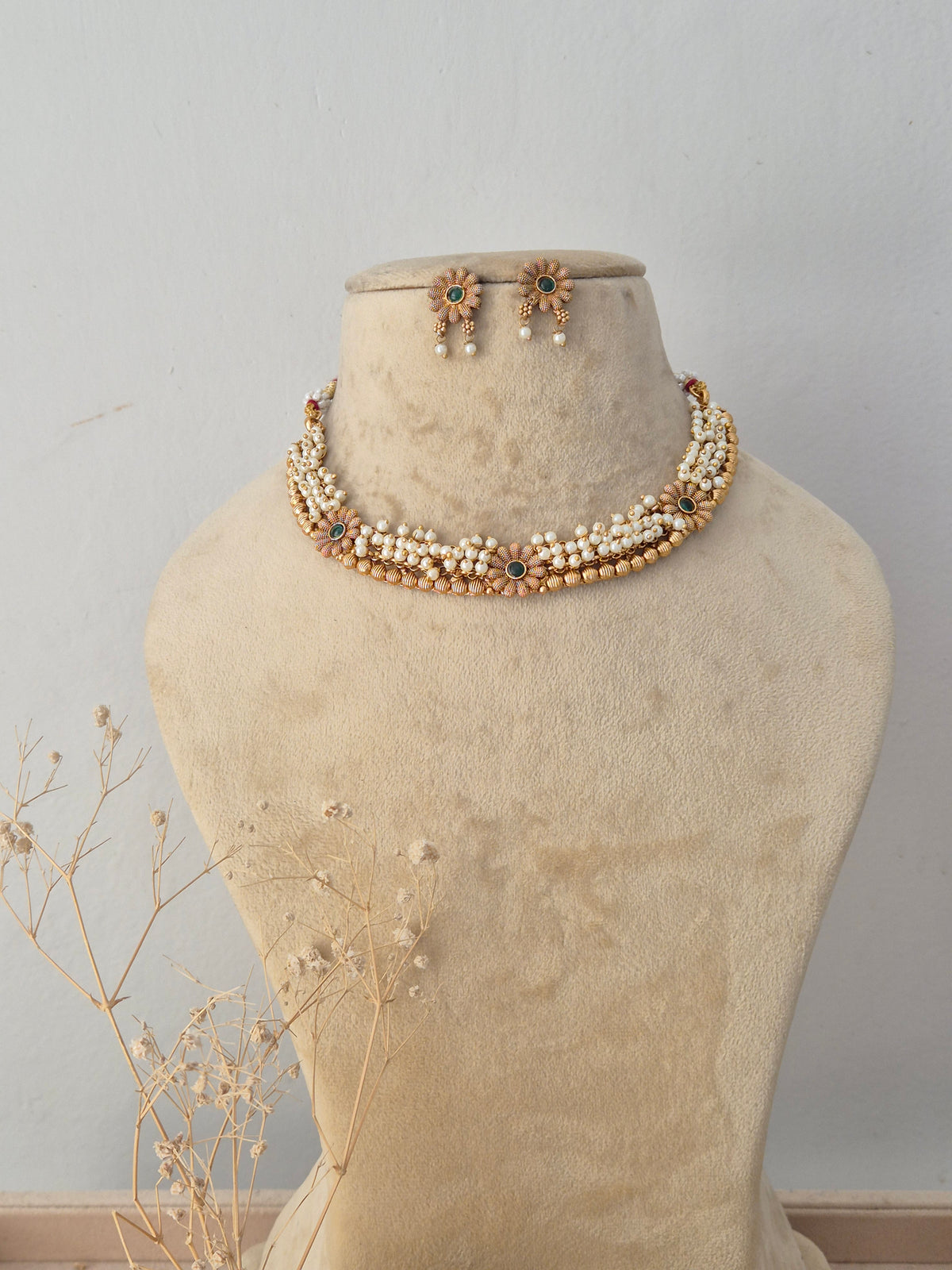 Traditional Indian pearl cluster choker necklace with subtle green and red stone accents by Naitri.in