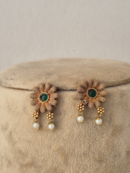Handcrafted ethnic brass alloy choker featuring delicate pearl beads, textured gold accents, and matching earrings by Naitri.in