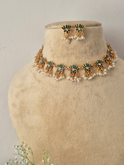 Handcrafted antique gold statement jewelry set showcasing green stone embellishments and tiny hanging seed pearls, perfect for festive styling