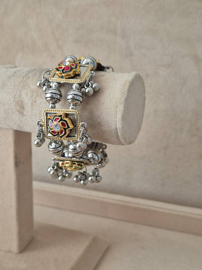 Statement mixed-metal festive Kada bangle featuring intricate rows of silver beads, gold-toned frames, and a hand-painted floral centerpiece by naitri.in