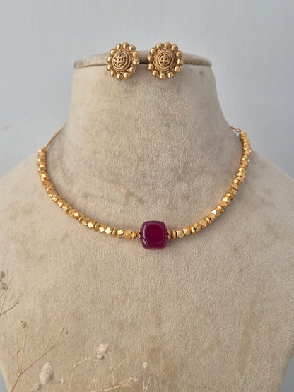 Ornate gold-toned fashion jewelry set with a detailed pendant design and matching earrings for ethnic wear by Naitri.in
