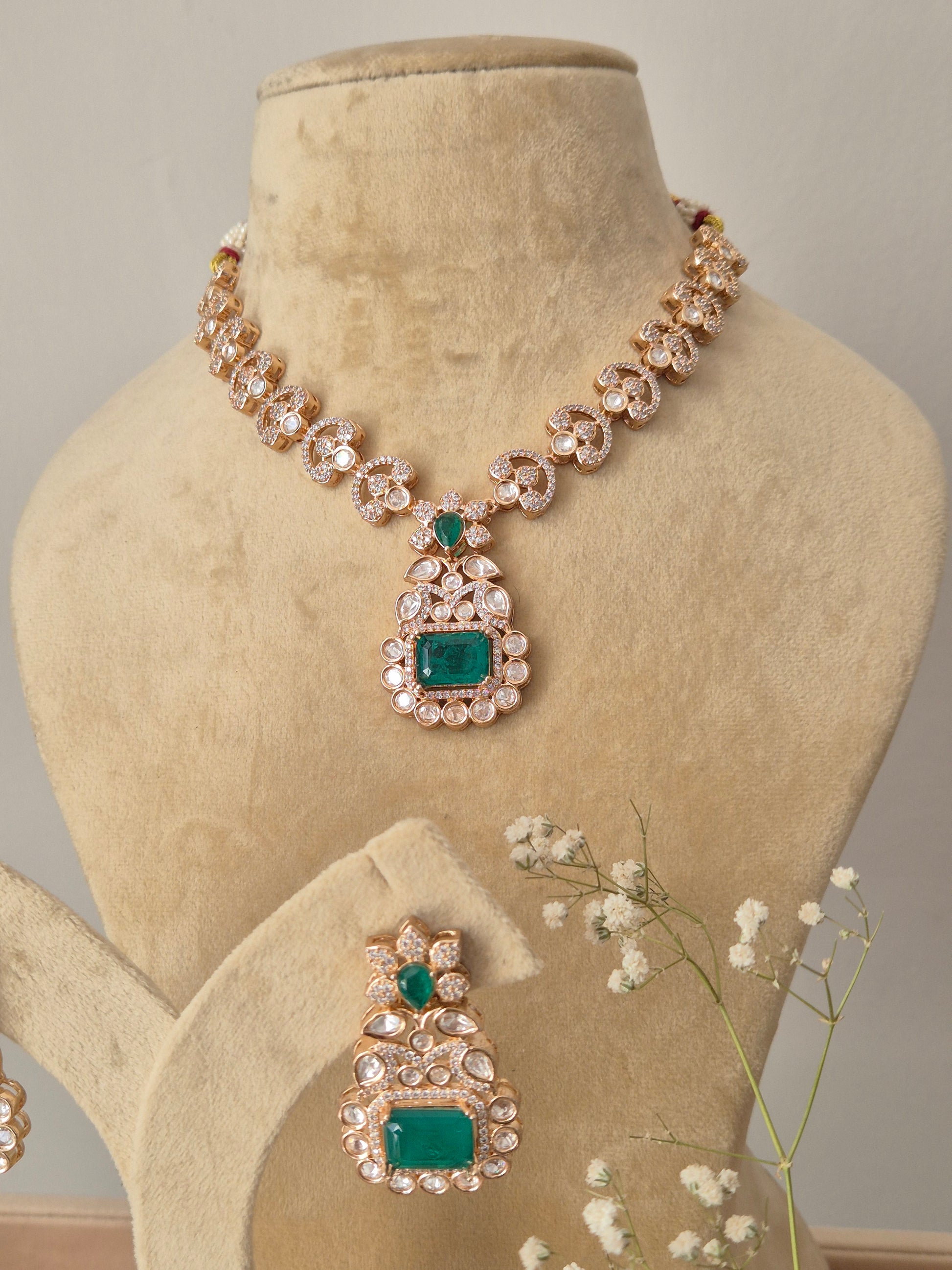 A statement handcrafted American diamond necklace set designed for weddings and special occasions and Modern Indian festive jewelry: Emerald green and gold AD necklace set for sarees, lehengas, and fusion wear by naitri.in