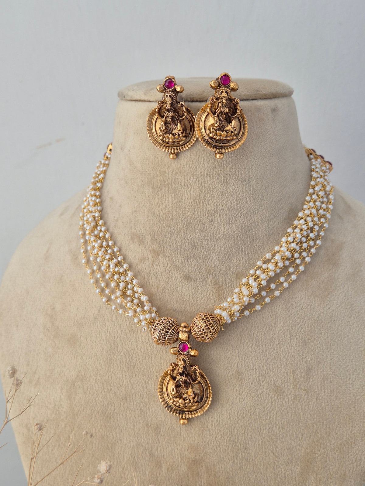 Ornate ethnic fashion jewelry set with a layered chain design, paired with matching statement earrings for festive and bridal wear by Naitri.in