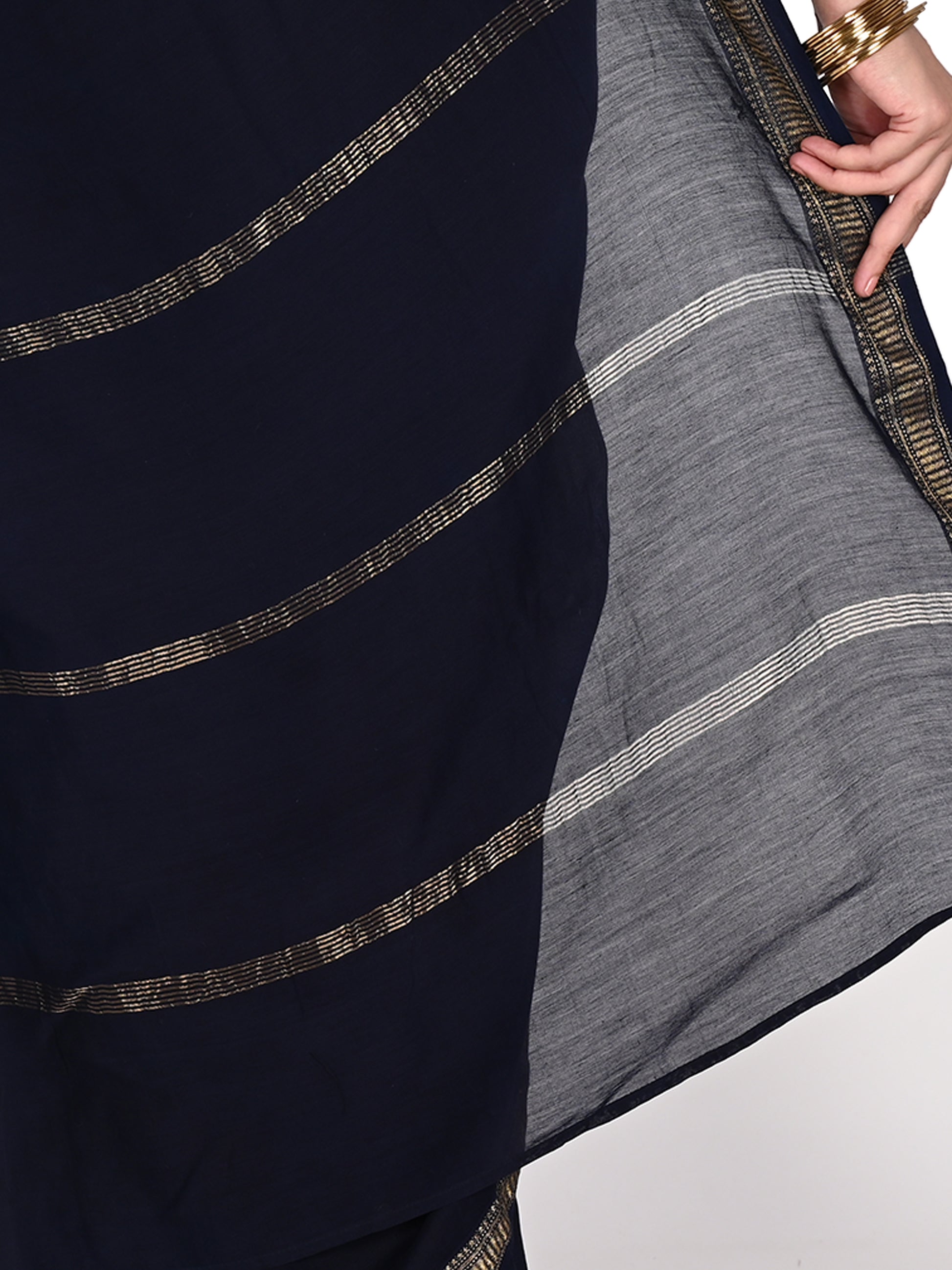Close-up of the Azula navy blue saree showing the subtle sheen of Maheshwari cotton-silk fabric and intricate white geometric hand block prints using natural dyes by naitri.in