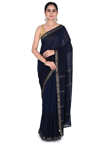 A model wears the navy blue Azula Maheshwari cotton-silk saree, featuring natural dye hand block prints, a gold zari border, and a classic drape against a white background by naitri.in
