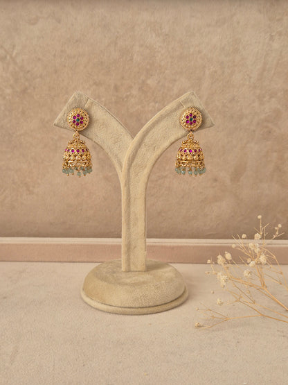 Babli handcrafted gold-finish jhumka earrings with ruby and green stone accents by naitri.in