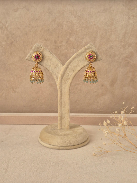 Babli handcrafted gold-finish jhumka earrings with ruby and green stone accents by naitri.in
