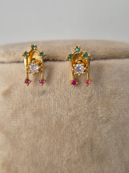 Minimalist gold-toned earring  with dangling teardrop motifs in vibrant pinkish-red and sparkling clear crystals, by naitri.in