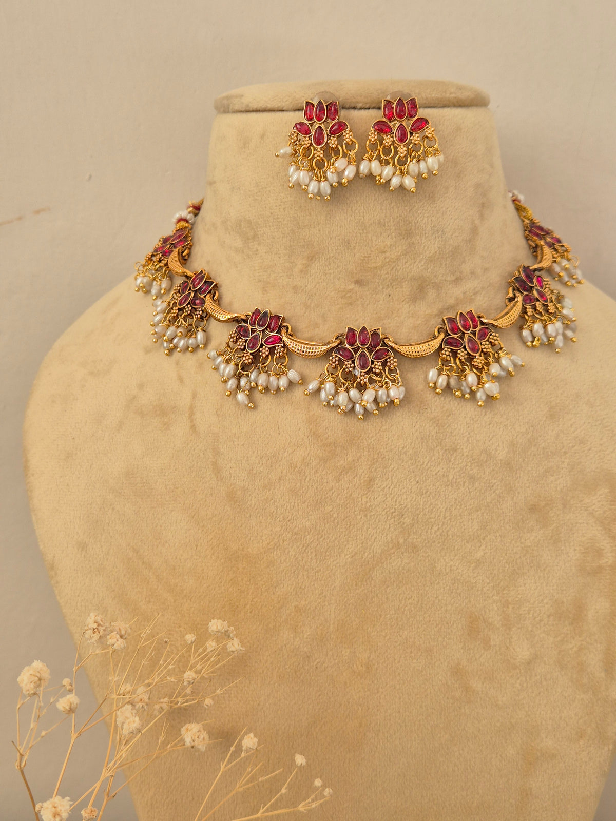 Barnali  Necklace Set by Naitri featuring an ethnic gold-plated choker and matching traditional statement earrings with red stones and pearls for festive occasions by naitri.in
