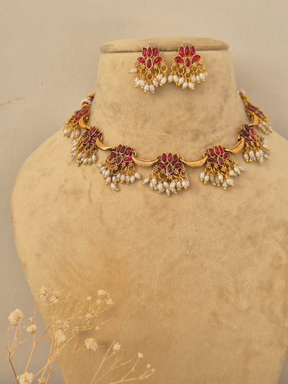 Barnali  Necklace Set by Naitri featuring an ethnic gold-plated choker and matching traditional statement earrings with red stones and pearls for festive occasions by naitri.in