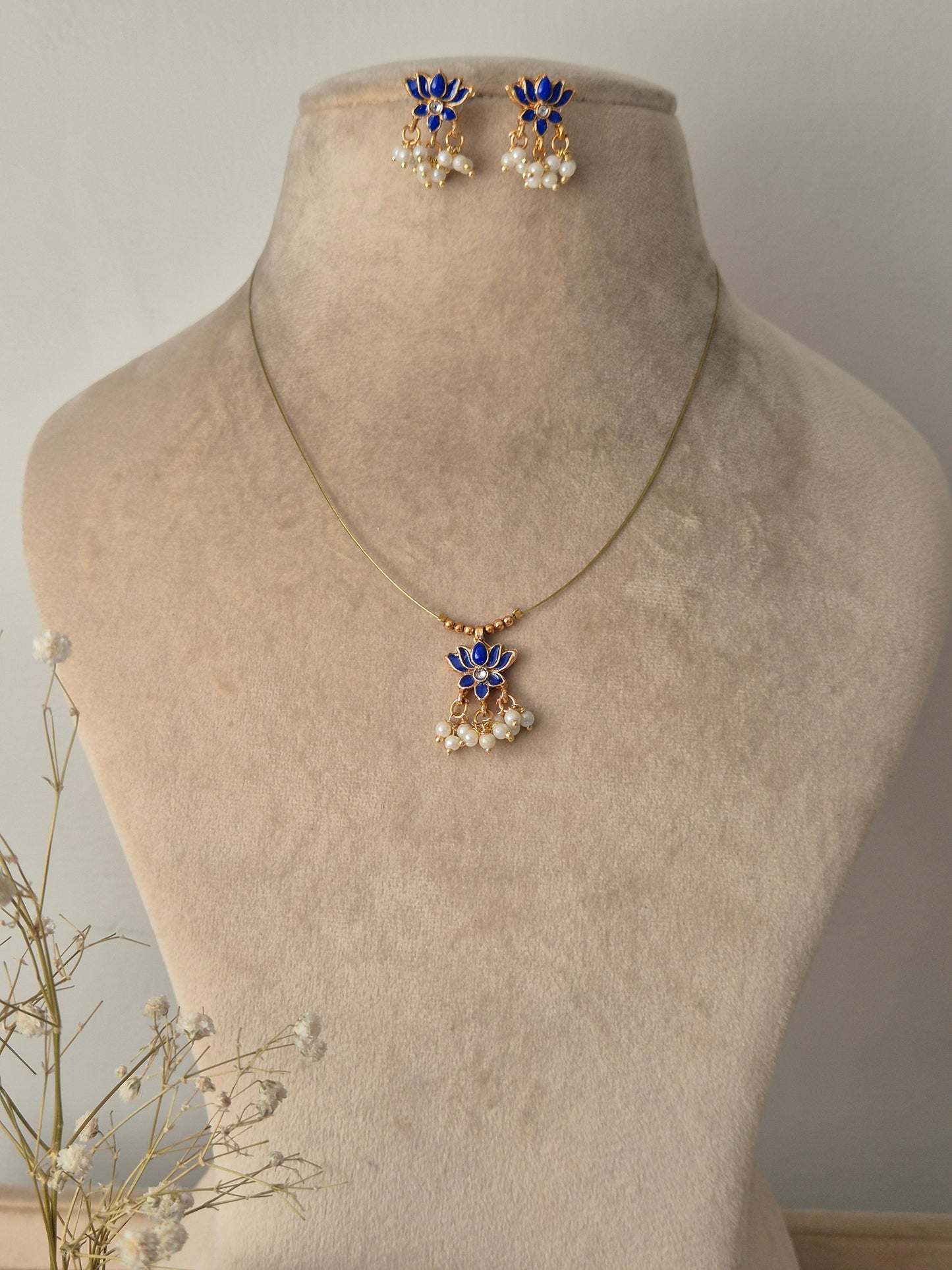 Necklace with blue lotus  design invisible chain light weight elegant and minimal jewellery set by naitri