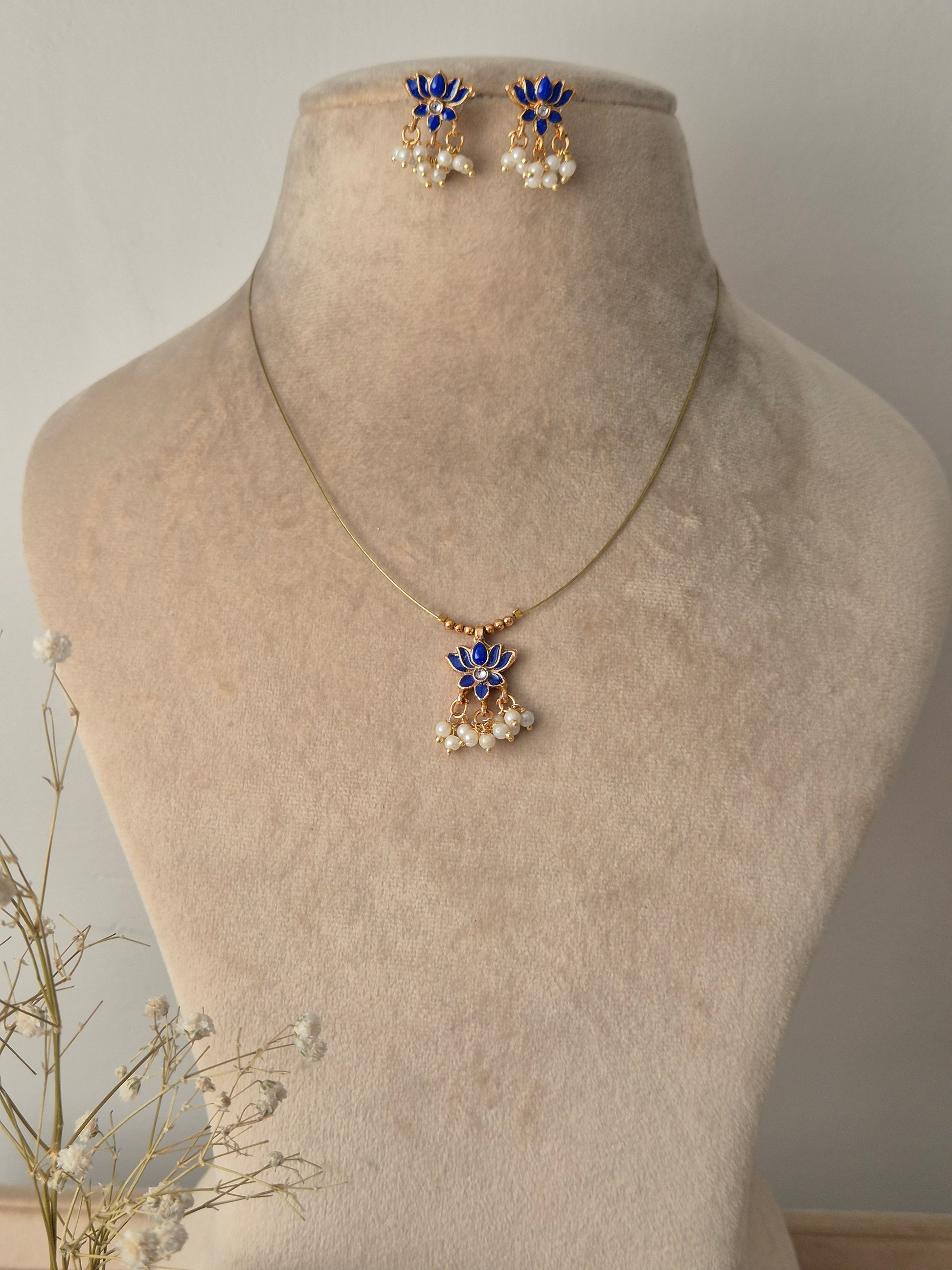 Necklace with blue lotus  design invisible chain light weight elegant and minimal jewellery set by naitri