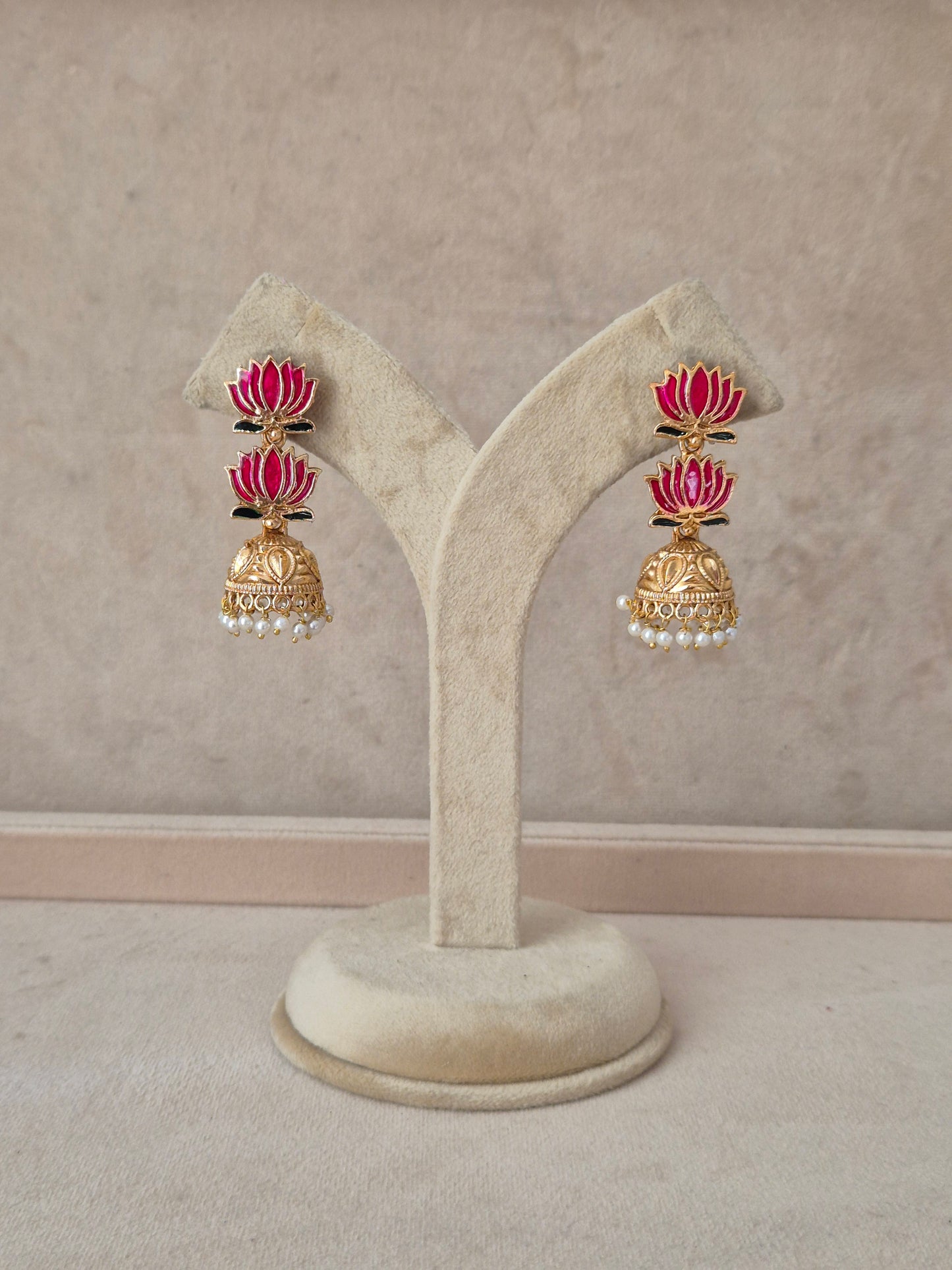 A pair of gold-toned traditional Indian earrings with pink enamel and white pearl accents, by naitri.in