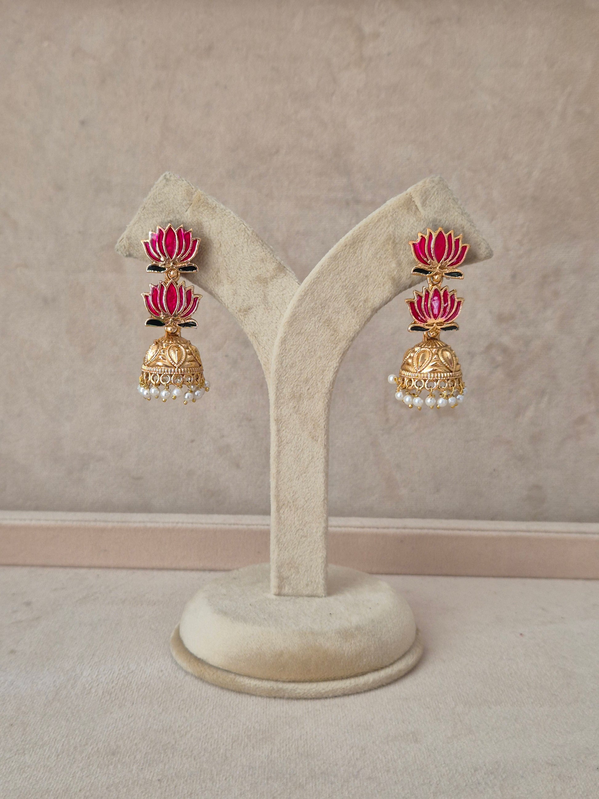 A pair of gold-toned traditional Indian earrings with pink enamel and white pearl accents, by naitri.in