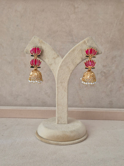 A pair of gold-toned traditional Indian earrings with pink enamel and white pearl accents, by naitri.in