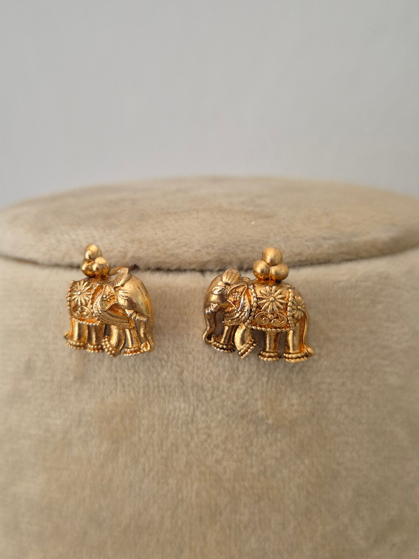Gold elephant-shaped earrings by naitri.in